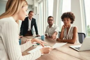 business meeting group of young business people looking at documents and discussing something while