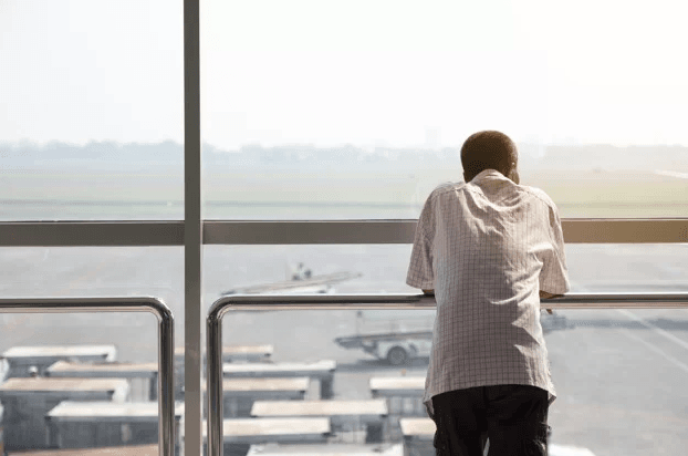 rear view alone man waiting plane airport